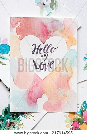 crafting, art, love concept. marvelous valentine that was made professionaly by artist with watercoloures and thin brush, it is placed among different pieces of sheet