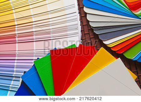 Set of open Pantone/RAL color cards on bamboo mat
