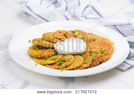 Traditional Hanukkah dish latkes - potato pancakes with sour cream with