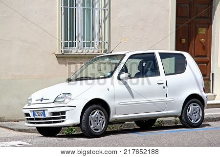 Pisa Italy - July 31 2014: White motor car Fiat Seicento in the city street.