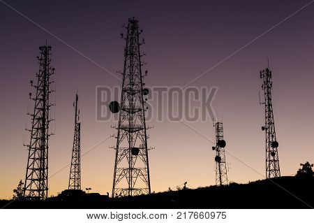 vehiculars of communication against the evening sky