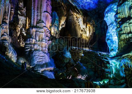 Postojna cave, Slovenia. Formations inside cave with stalactites and stalagmites. Low light image.