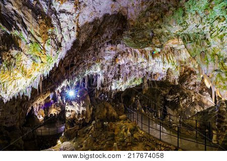 Postojna cave, Slovenia. Formations inside cave with stalactites and stalagmites. Low light image.