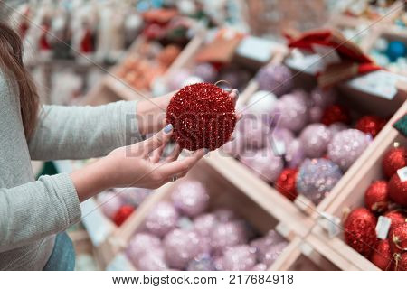 customer hands choosing Christmas tree decoration balls. difficult decision. Various choice