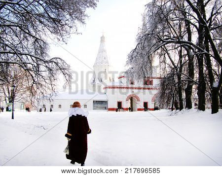 Russian Church In Kolomenskoye In Winter. A Woman Goes To The Temple.