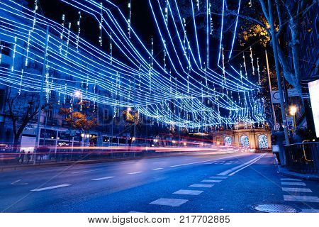 Madrid, Spain - December 8, 2017: Alcala Street in Madrid at night on Christmas time. Long exposure shot with light trails of traffic and blurred people