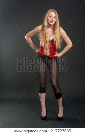 Beautiful sexy blonde female model dressed in a Santa Claus dress. Sensual girl for Christmas