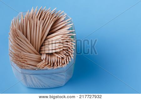 Pile of tooth stick in jar on blue