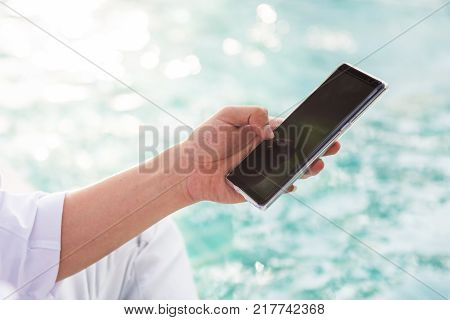 Using Smartphone By Businessman At Pool