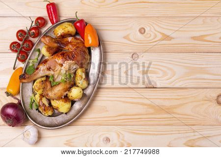 roast chicken with potatoes and vegetables. copy space. top view.