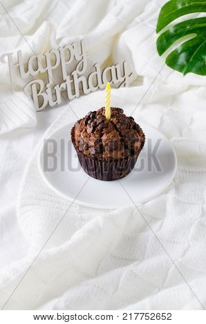 Birthday muffins or capkakes with chocolate on a wooden tray in bed. White background. Sweet food. Festive mood copy space flat lay