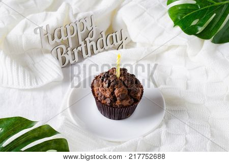 Birthday muffins or capkakes with chocolate on a wooden tray in bed. White background. Sweet food. Festive mood copy space flat lay