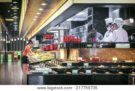 BANGKOK THAILAND NOVEMBER 19: The chefs and manager works behind the food bar in Hot Pot Buffet restaurant on November 19 2017 in Bangkok.