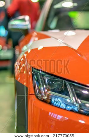 red racing sports car shines and shimmers in the lights of the auto show