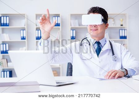 Young doctor with vr virtual reality headset working in the offi