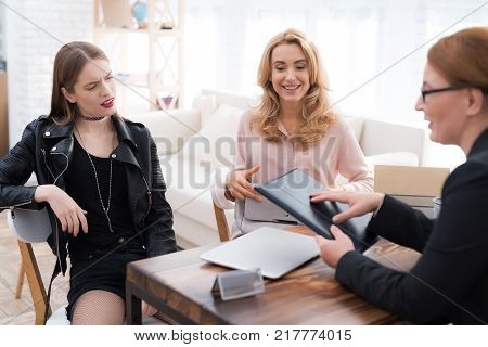 A teenage girl with her mother at a psychologist's reception. The girl has a complicated character. She does not listen to adults. She loves rock music and dressed in a leather jacket.
