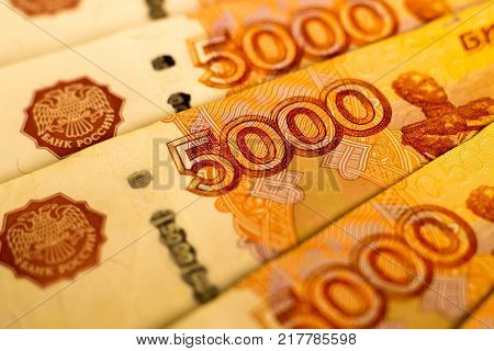 Russian money banknotes with biggest value (5000 rubles) close up. Macro shot of orange  banknotes. Finance concept.