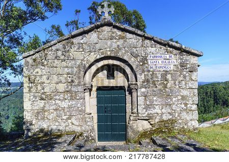 Small stone parish called "Santa Eulalia de la Espenuca" located on the hill called "La Espenuca" in Galicia (Spain). With very green vegetation and a very blue sky no people