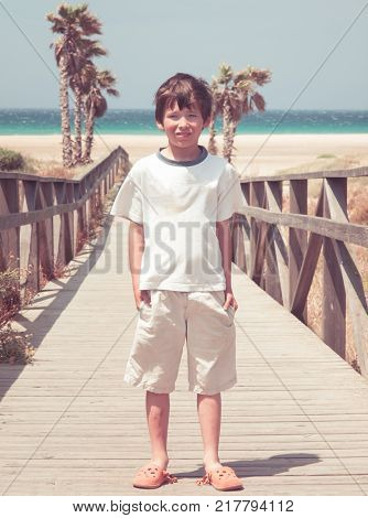Typical family photo of a boy at the beach of Tarifa vintage look