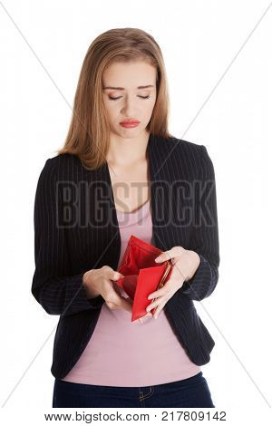 Beautiful caucasian business woman checking her empty red wallet.