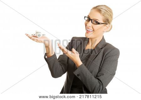 Businesswoman with plane toy in hand