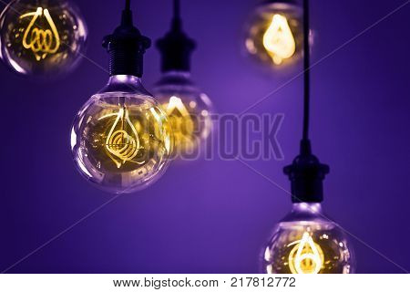 Group of Ultra Volet lamps with interesting shape of tungsten filament and yellow light. Color of the year 2018.