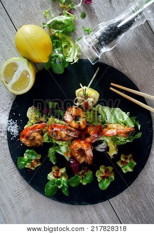 Barbecue grilled prawns with guacamole salad close-up