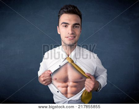Businessman tearing off his shirt and showing mucular body concept on background