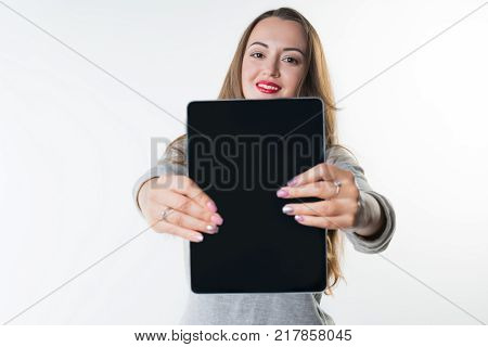 Business concept - Young woman with an empty tablet screen isolated on white background. Free Copyspace
