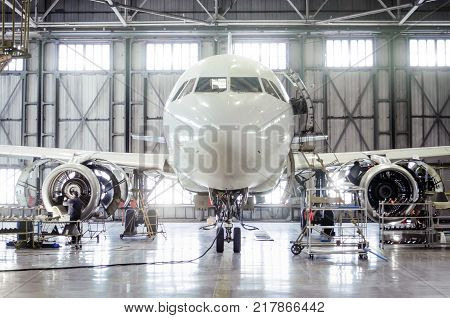 Passenger aircraft on maintenance of engine and fuselage repair in airport hangar