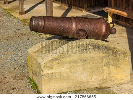 Mini Rusted Cannon On Concrete Pedestal On Display
