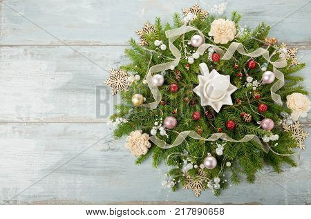Decorated Advent wreath with white candles on blue wooden background useful as christmas decoration