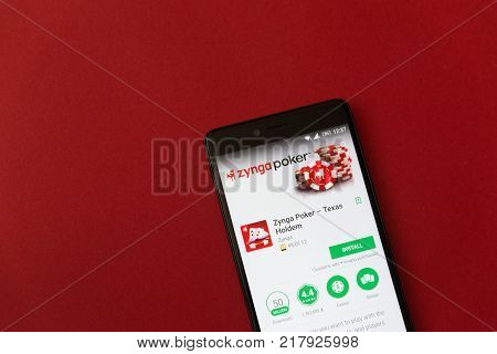 Los Angeles, december 11, 2017: Smartphone with Zynga poker game application in google play store on red background