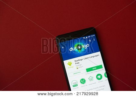 Los Angeles, december 11, 2017: Smartphone with Duolingo application in google play store on red background