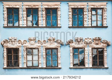 Ten windows on The blue facade of the old vintage houses