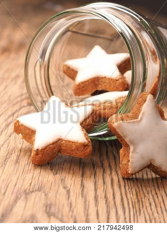 Star shaped cinnamom cookies on a wooden table close up Christmas sweets