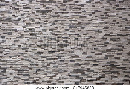 Decorative brick wall from concrete facing tiles as background or texture.