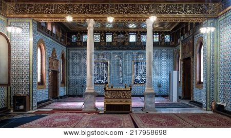 Cairo, Egypt - December 2, 2017: Interior of public mosque of Manial Palace of Prince Mohammed Ali Tewfik with wooden golden ornate ceilings
