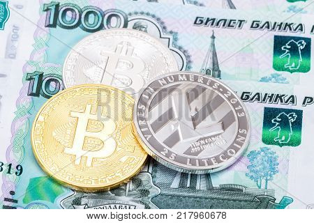 Coins of Cryptocurrency lying on the russian ruble banknotes. Business concept of new virtual money
