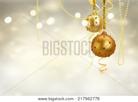 Golden christmas balls garland on glowing silver background