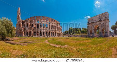 Panorama of The Arch of Titus and Colosseum or Coliseum, also known as the Flavian Amphitheatre, the largest amphitheatre ever built, in the centre of the old city of Rome, Italy.