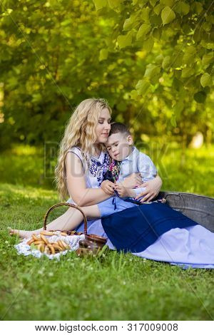 Portrait Of Happy Caucasian Mother With Her Little Kid. Posing With Basket Full Of Bread Rings Outdo