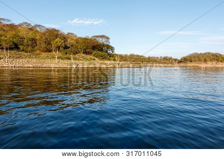Wooded Shoreline Of The Massive Reservoir Named Lake El Salto In Sinaloa, Mexico.  Body Of Water Is 