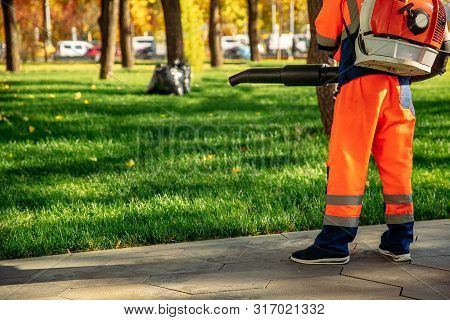 Leaf Blower Male Worker Removes Leaves Lawn Of Garden Autumn