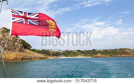 St Helier, Jersey, United Kingdom, - 07, 25, 2019: Red Ensign And Le Portelet Coastal View From The 