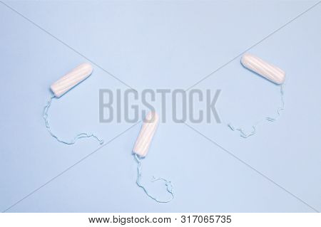 The Uncompressed Tampons White On A Blue Background, The Concept Of Women's Intimate Hygiene And Hea