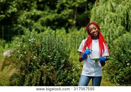 African Red Haired Volunteer Woman With Clipboard In Park. Africa Volunteering, Charity, People And