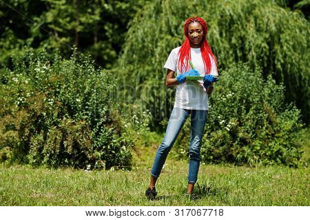 African Red Haired Volunteer Woman With Clipboard In Park. Africa Volunteering, Charity, People And