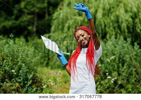 African Red Haired Volunteer Woman With Clipboard In Park. Africa Volunteering, Charity, People And