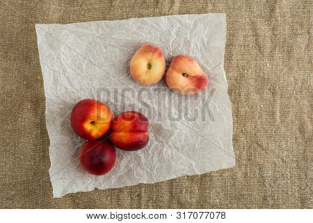 Donut Peaches Also Known As Saturn Peaches And Nectarine On A Rustic Canvas Background. Healthy Food